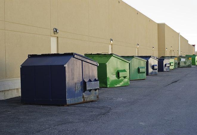 construction workers disposing of debris in large dumpsters in Delafield